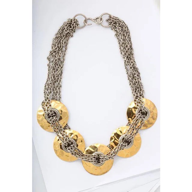 This is part of Chairish’s Costume Jewelry assortment. Good looking brass disk and silver chain necklace.