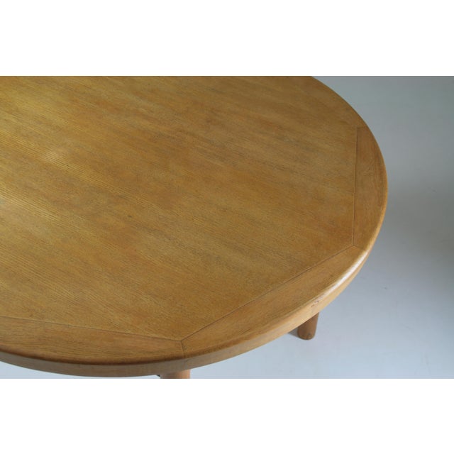 Round “Dordogne” model table by Robert Sentou and published in the 1950s. Structured in solid ash and veneer. Table with a...
