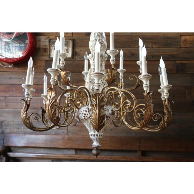 Stunning vintage Italian 18-light chandelier dating to circa 1970s, featuring an elaborate combination of hand-carved wood...