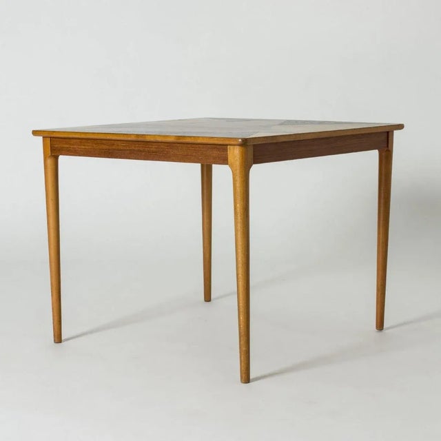 Lovely Swedish midcentury occasional table, made from teak. Square table top with a striking graphic design of inlayed...