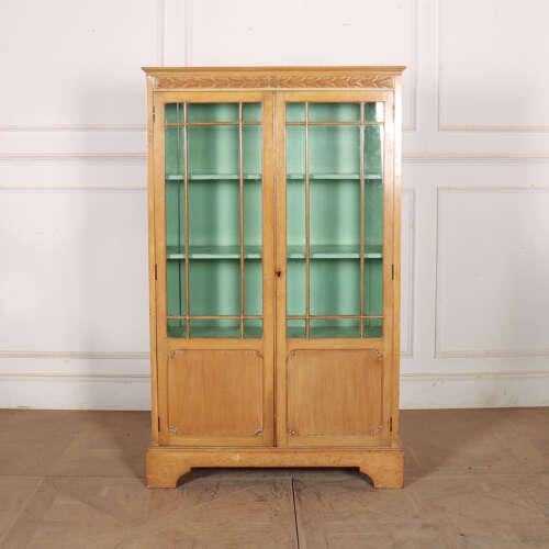 Small English 19th century pretty bleached walnut two door bookcase. Nice small size. 1880. This piece is designed in the...