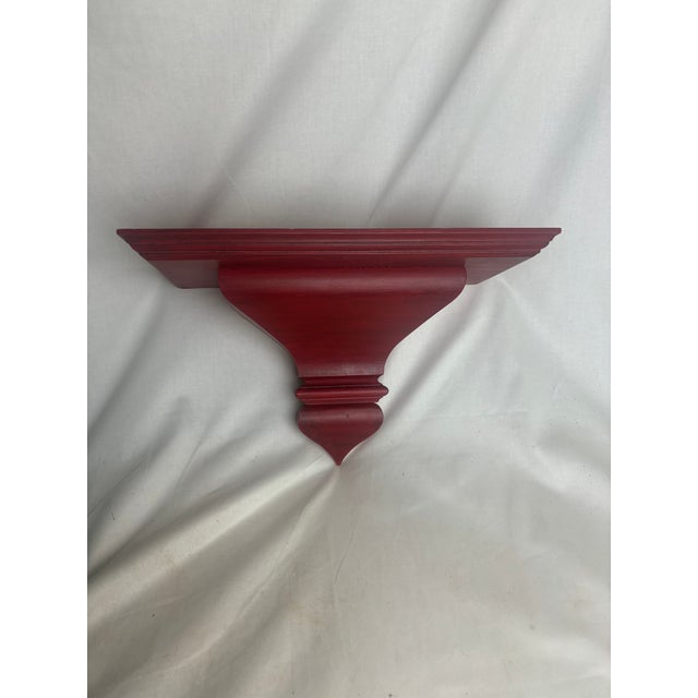 These wall brackets would be perfect for adding some color and detail into your space. The wood is sturdy and the red...