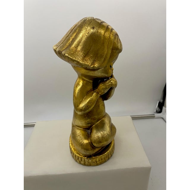 I remember counting the coins in this bank.. late 1950's-60's. It is a very sweet seated little girl, most likely Chalk...