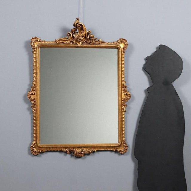 Carved frame in Rococo style with rocaille motifs and curls and gilded with fake gold. Made in the 20th century. This...