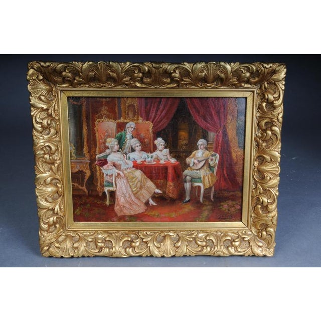 This oil painting, housed in a magnificent, gilded frame, depicts an elegant Rococo society and is by the Austrian painter...
