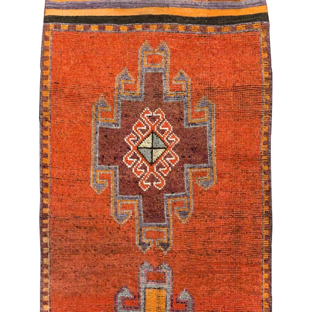 This mid-20th-century Turkish Anatolian tribal runner presents four large, vertically aligned medallions across a...