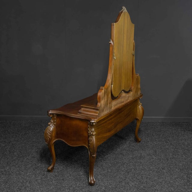 A superb and large Victorian mahogany dressing table of French Rococo design. With bold cabriole legs, richly carved to...