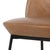 Slim, subtly splayed legs of black-finished iron support chamfered top-grain leather seating in a versatile tan.