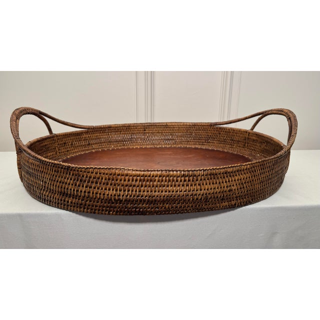 A beautiful tightly woven wicker rattan encompasses this monumental size tray. An oval bottom base supported underneath...