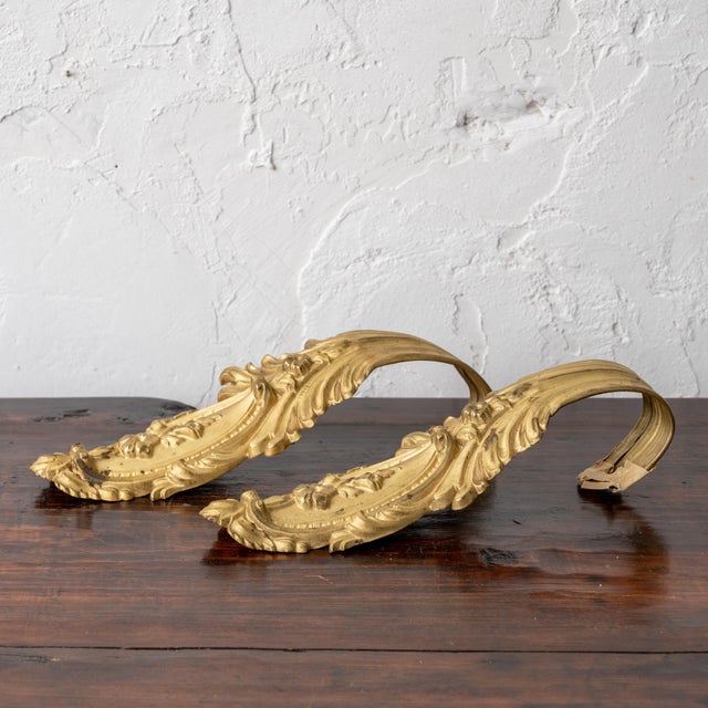 A pair of antique gilt French curtain tie backs. 3 ¼ inches wide by 9 inches tall by 2 ¼ inches deep
