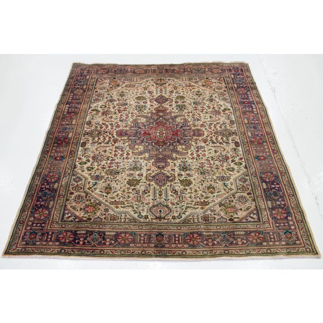 This Vintage room size Persian Shiraz has an allover Design with multicolor accents In a beige color background. This rug...