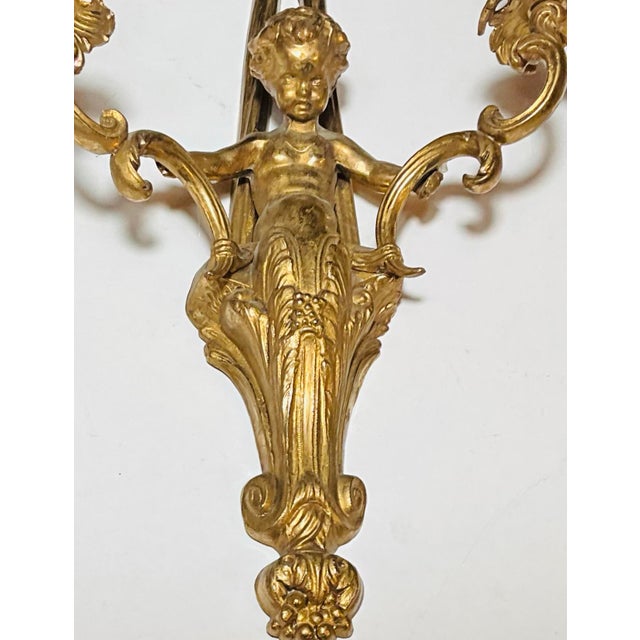 French Early 20th Century Pair of Monumental 22” French Louis XVI Style Gilt Bronze Cherub Two-Light Wall Sconces With Ribbon Bows For Sale - Image 3 of 7