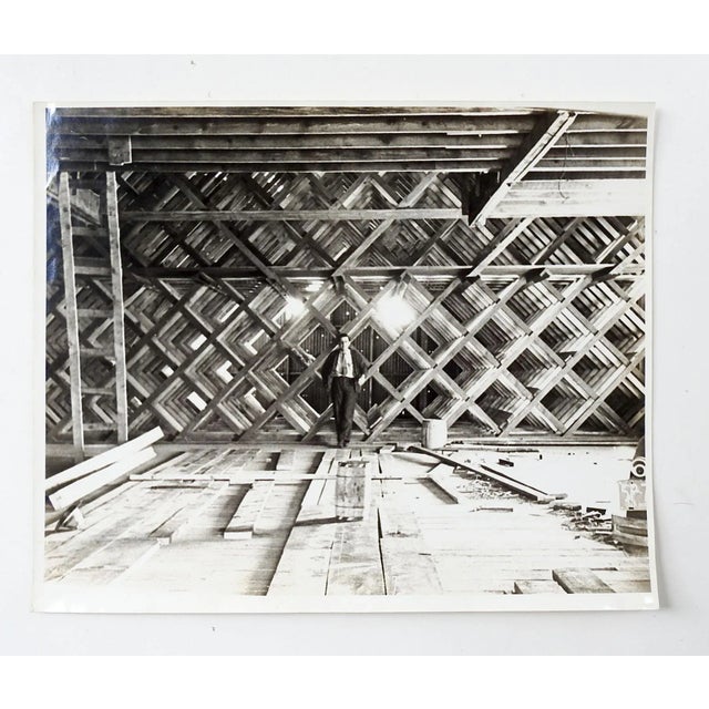 Vintage circa 1940's photograph of man standing in the interior truss system of a building. Great graphic perspective...