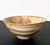 An early ceramic tea bowl (chawan) from Korean dated to 16th century of the Joseon Dynasty. The gracefully potted and...