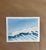 A minimalist watercolor seascape capturing the crisp beauty of an ocean wave just before it breaks. Rich cobalt blues and...
