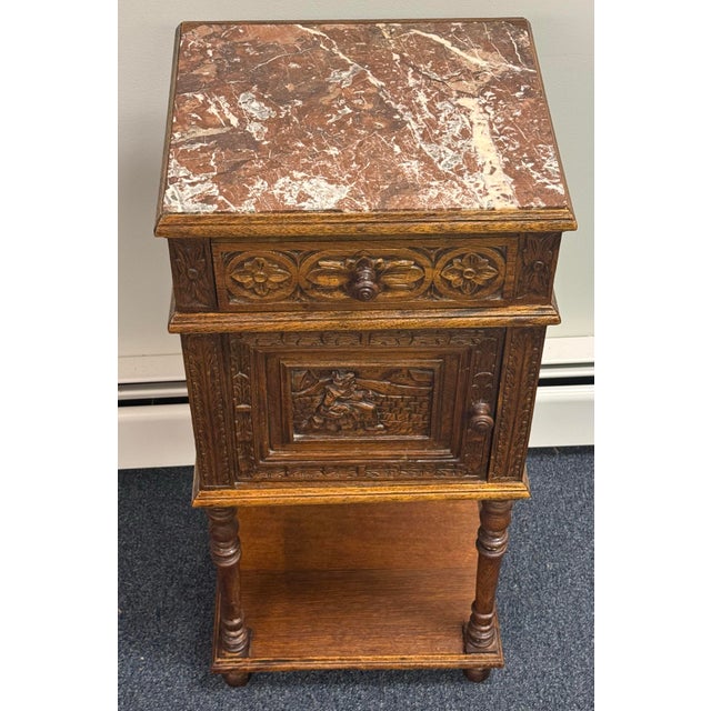 Antique French Breton or Brittany-style carved oak nightstand with a marble top, likely dating from the late 19th century....