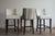 A set of three Wesley Hall bar stools in a custom two-tone treatment: cream linen on the inside back and seat, with a...