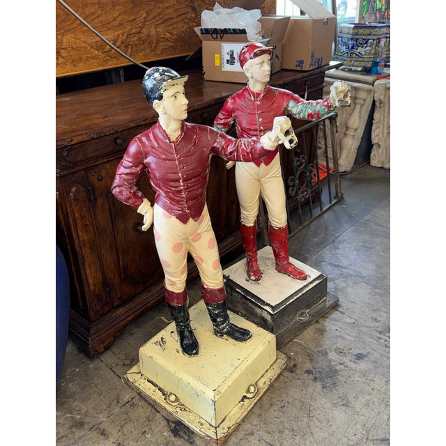 A charming and increasingly difficult-to-find pair of vintage lawn jockey figures, each standing proudly with an...