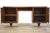A mid century modern walnut double bank desk with two doors opening to shelving. With a finished back, you can place this...