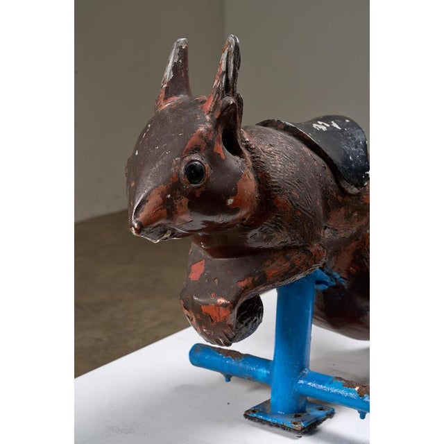 This vintage cast aluminum carousel squirrel figure is a charming and distinctive piece of mid-century industrial folk...