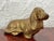 Solid brass figurine of a sitting spaniel. The dog has long feathered ears and a gently raised head. Fine cast brass...