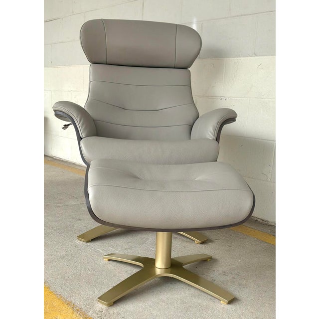 Timeless Mid-Century Eames Style Italian White Leather Lounge Chair and Ottoman, dark taupe wood frame, brass metal base,...