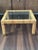 A stylish vintage wicker coffee table featuring a finely wrapped rattan frame accented by brass-capped feet and a brand-...