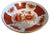 Porcelain polished brass-encased bowl in a vibrant hand-painted floral-motif in shades of coral, tan, black, and white....