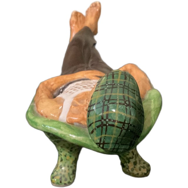 Inject a touch of mid century into your interior with this charming, hand painted ceramic figurine. Depicting a gentleman...