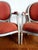 Pair of Louis XVI style armchairs in molded wood, painted white and upholstered in salmon jacquard fabric with orange...