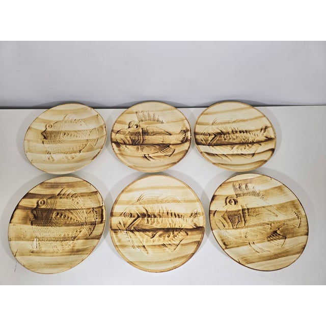 This fine earthenware dinner service, produced by the Longchamp faience factory in the 1970s, is decorated with a stylized...