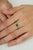 This minimalist solitaire ring features a 0.83-carat natural oval-cut emerald, measuring 5 x 7 mm, set as the central...