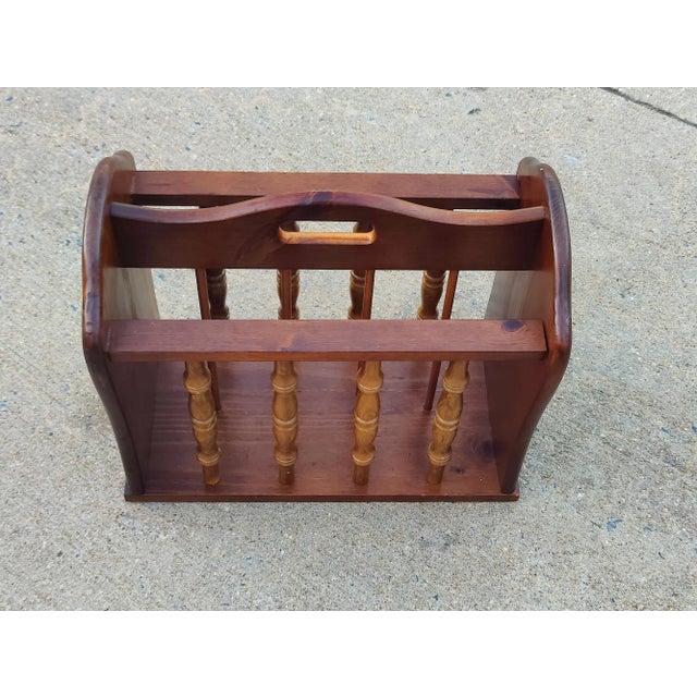 This is a lovely vintage magazine holder.. It's made from solid wood with a medium brown stained finish. Has a divider in...