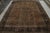 Hand-knotted in wool, this 8x11 antique Turkish Isparta rug, circa 1920-1930, enjoys rich brown and navy blue tones in...