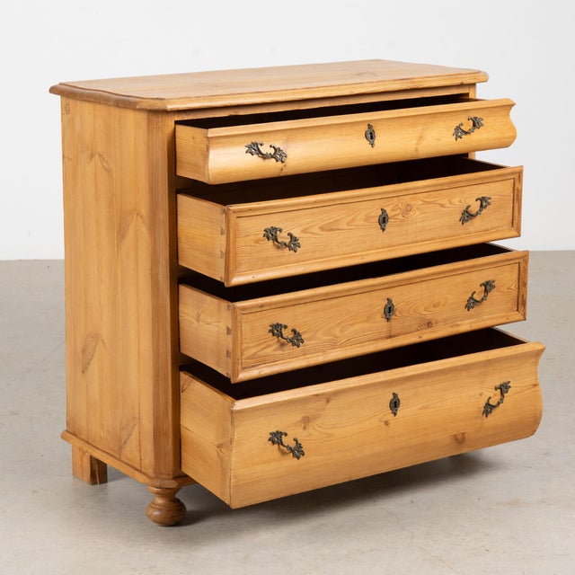 19th century Danish chest of four drawers, crafted in pine with a warm waxed finish that highlights the natural variation...