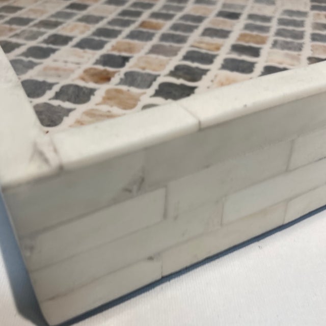 The base of the tray is inlaid with gray and peach, the outside is alabaster Colored inlay. There are handles at either...