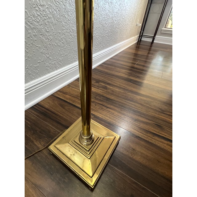 A refined vintage brass floor lamp featuring an elegant acanthus leaf capital and integrated glass tier, blending timeless...