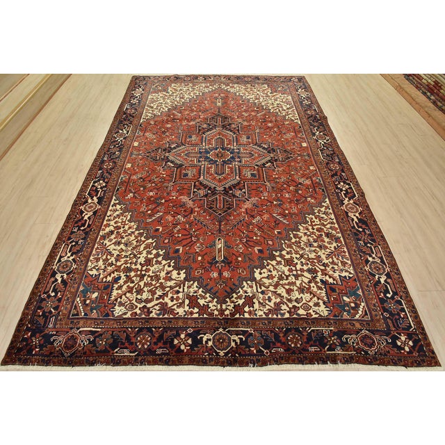 This authentic vintage, traditional, tribal Heriz rug is hand-knotted with an all-wool pile on a cotton foundation. This...