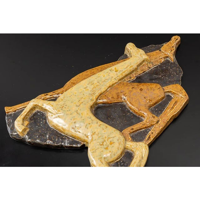 Glazed ceramic relief with two horses to hang on the wall. Numbered on the back and with the remains of an old sticker...