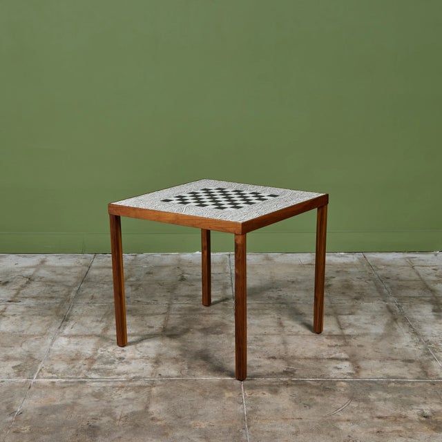 Square game table in the style of Gordon & Jane Martz. The table top is inlaid with white ceramic tiles with a...