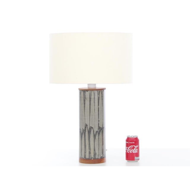 Mid century modern lamp in teak painted vinyl. Original electrical system. E27 bulb. New shade included. H foot, to the...