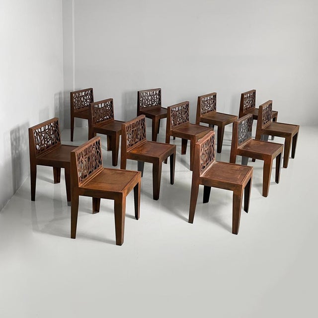 Italian postmodern chairs in Corten steel, 2010s Set of twelve chairs made entirely of Corten steel. The square seat is...