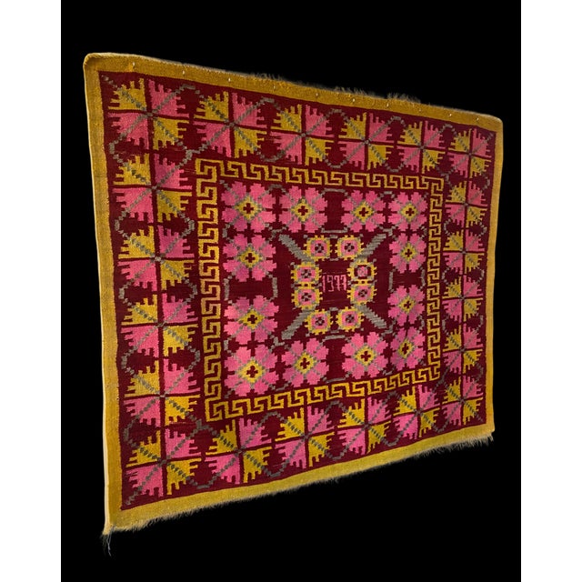 A striking Peruvian Andean textile handwoven in wool and dated 1977. This large-scale piece features a bold, symmetrical...