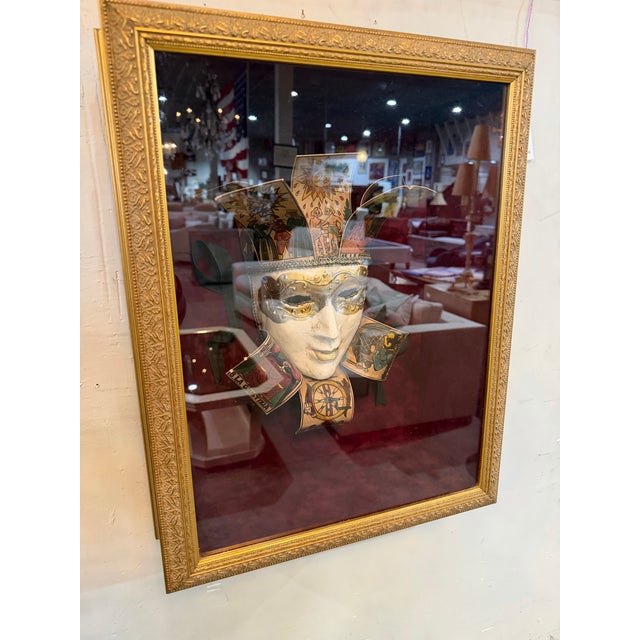 Bring a sense of Old World romance and theatrical elegance to your space with this Venetian mask displayed in an ornate...