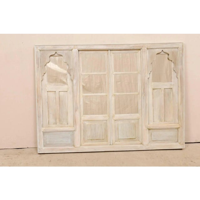 An Indian architectural panel with mirror from the mid-20th century. This vintage architectural panel features a...