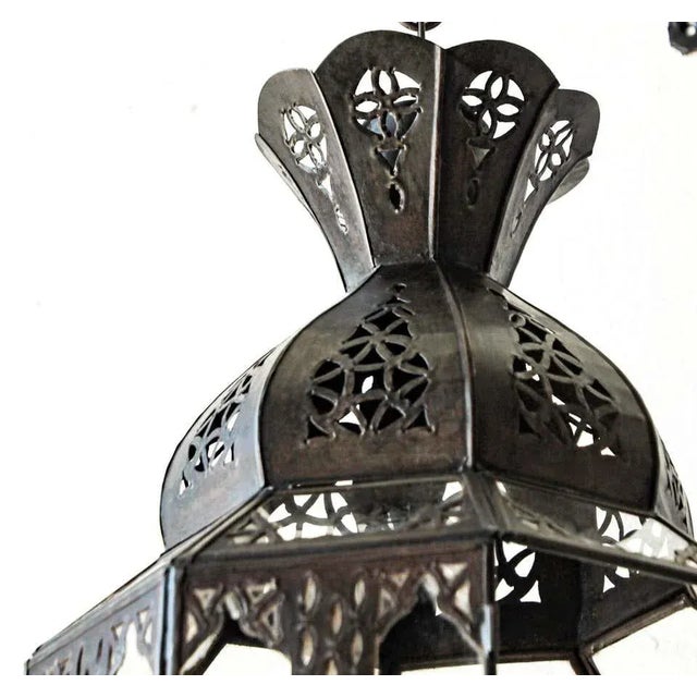 Moroccan bronzed metal and clear glass lantern. Moroccan Moorish lamp in octagonal shape with rust color metal finish and...