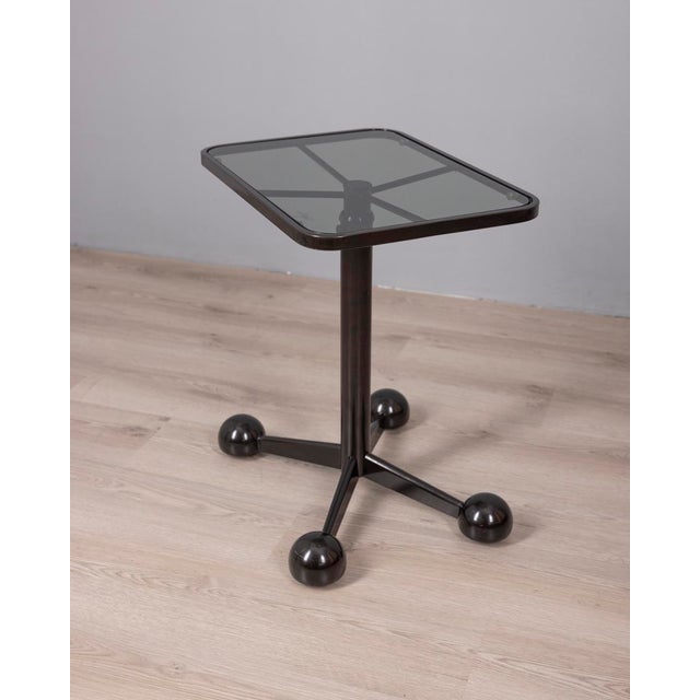 Black metal trolley table with smoked glass top, adjustable height, designed by Allegri Parma, 1970s. This piece has an...