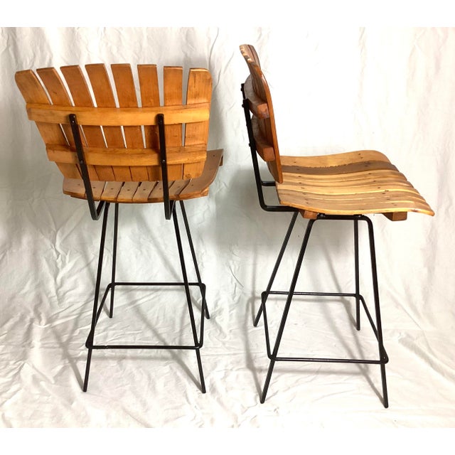 Pair Mid Century Slatted Bar Stools in the Style of Arthur Umanoff. These stools are counter height, measuring 35 inches...