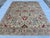 This exquisite hand-knotted wool area rug features a classic Serapi Heriz tribal design. The open center field showcases a...