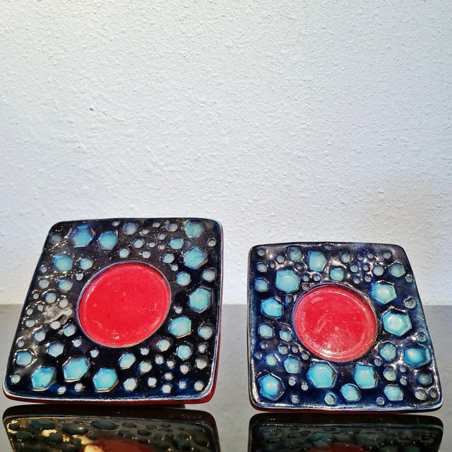 A pair of rare 1970s red, blue, and aqua candleholders from the DÜMLER & BREIDEN Studio series. Each is decorated with...